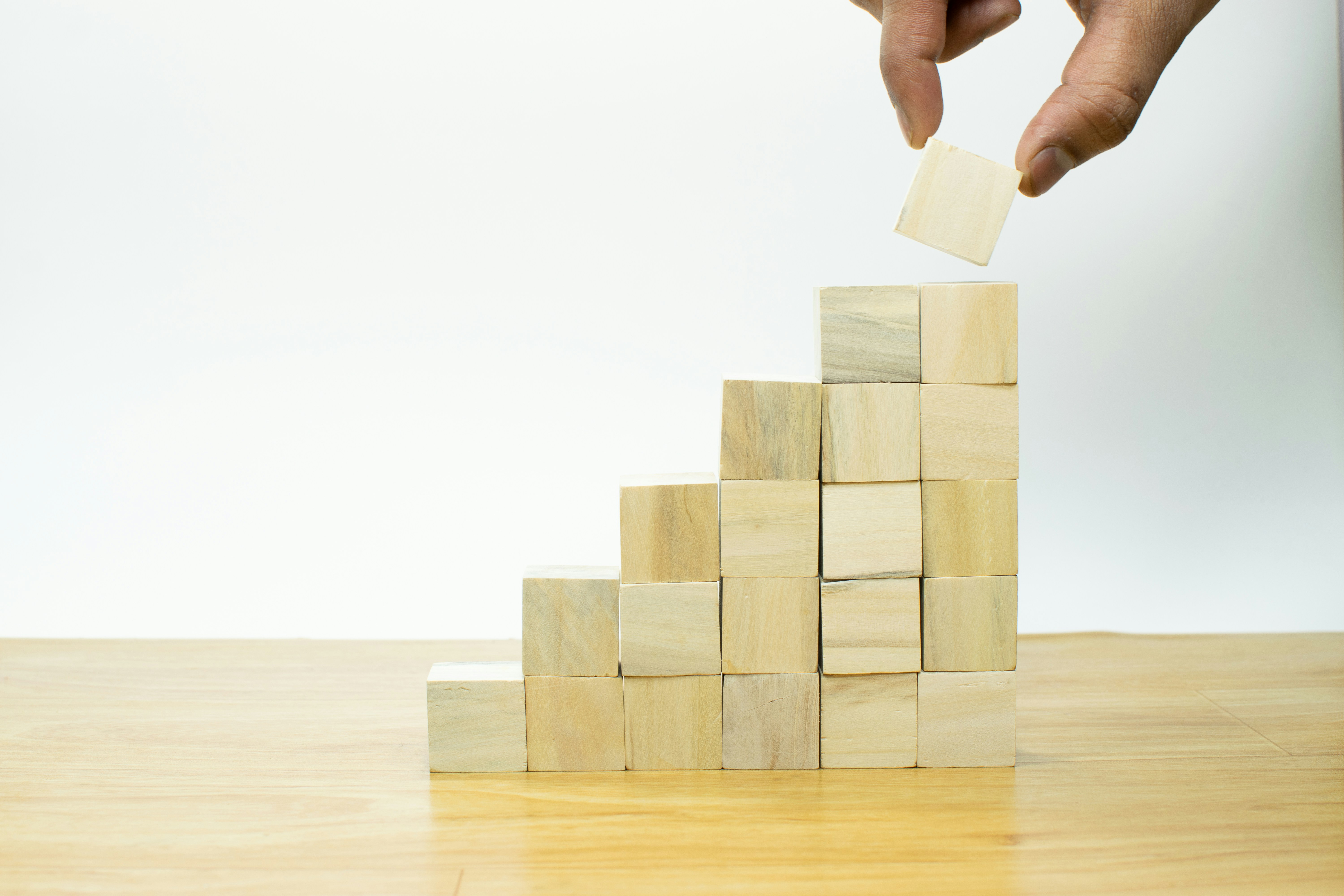 person stacking cubes creating a graph growing larger